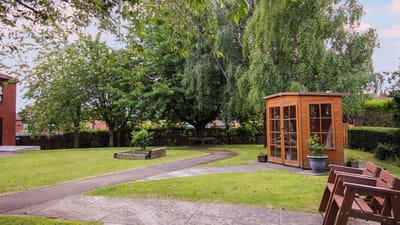 Well-maintained garden with a wooden shed