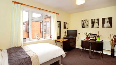 A private room with a bed and small dining area