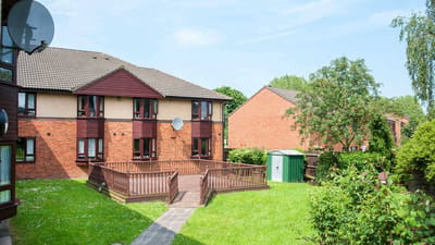 Exterior view of a senior living facility and garden area