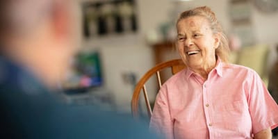 A smiling resident interacting in a common area