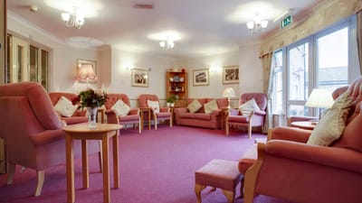Cozy common area with pink sofas and carpet