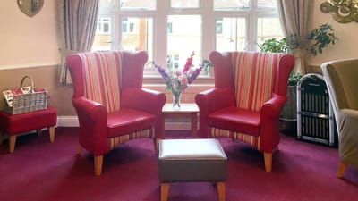 Cozy chairs and a flower vase in a common area