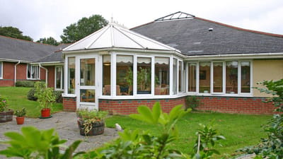 Exterior view of a senior care facility with garden