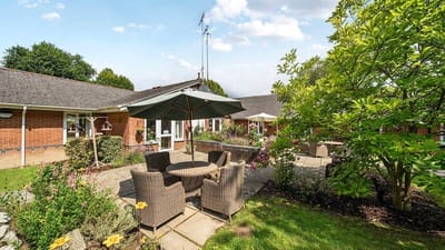 Outdoor seating area with flowers and greenery