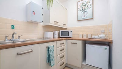 Bright kitchen area with appliances and decor