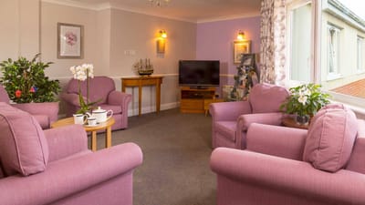 Cozy common area with pink chairs and plants