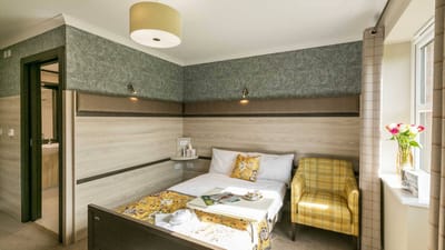 Cozy single resident room with warm decor