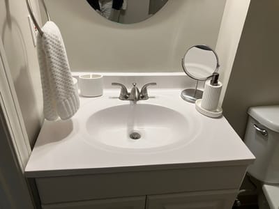 Clean bathroom vanity with sink and mirror