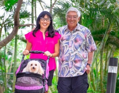 Residents enjoying a walk outdoors with a dog stroller