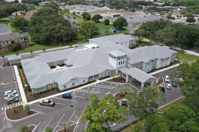 Aerial view of the facility with parking and landscaping