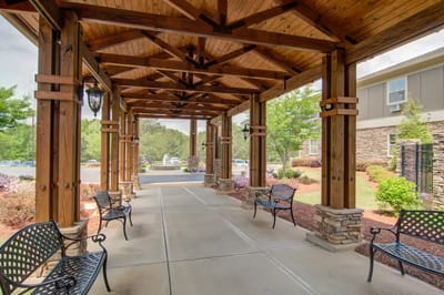 Covered walkway with benches in a senior living facility