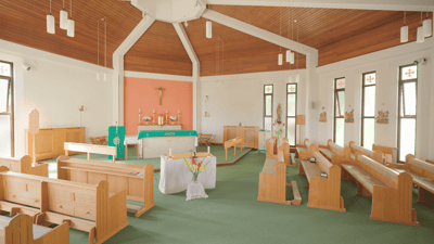 Interior view of a chapel with wooden benches