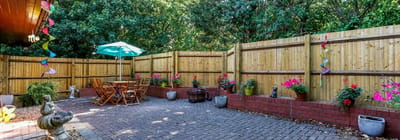 Well-maintained outdoor patio area with seating and flowers