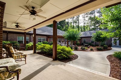 Outdoor patio area with seating and greenery