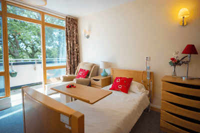Bright resident room with balcony access and cozy decor