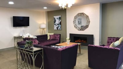 Cozy common area with purple seating and modern decor