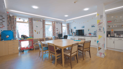 Bright common area with a large table and chairs