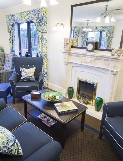 A cozy common area with a fireplace and seating