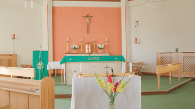 Interior of a chapel with altar and floral decorations