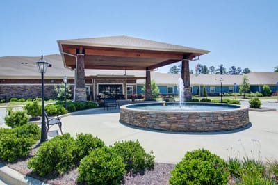 Exterior view of the facility with a water fountain