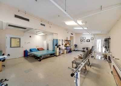 Physical therapy room with equipment and seating