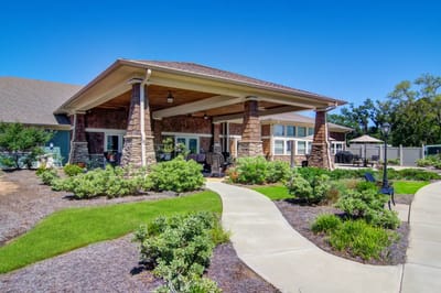 Exterior view of a senior living facility with gardens