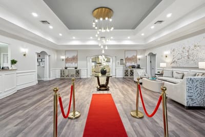 Bright lobby with a red carpet entrance and elegant decor