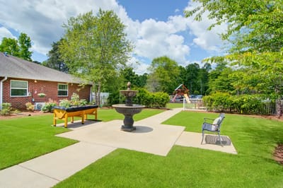 Outdoor garden area with a fountain and seating
