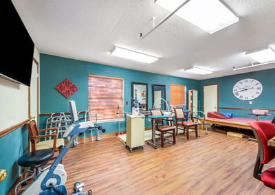 A well-lit rehabilitation room with exercise equipment