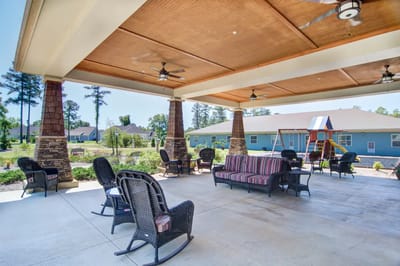 Outdoor seating area with shaded patio and playground