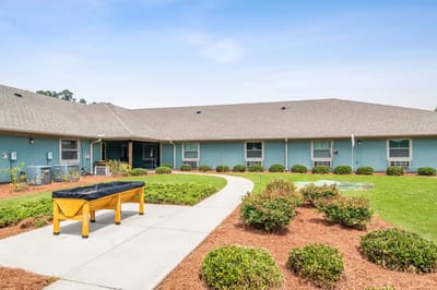Outdoor view of a nursing home with gardens and pathways