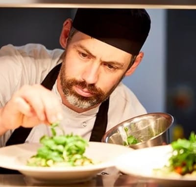 Chef preparing a dish in the kitchen