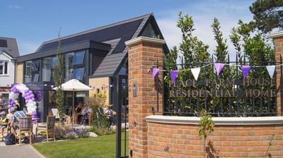 Exterior view of Place Farm House with residents and staff enjoying outdoor space