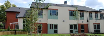 Exterior view of Newcross Care Home with landscaping