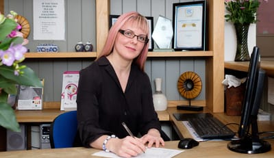 Staff member at a reception desk in the facility