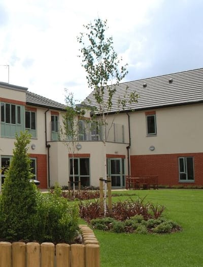 Outdoor space with landscaping in front of a care facility