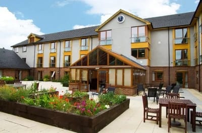 Exterior view of a senior facility with garden