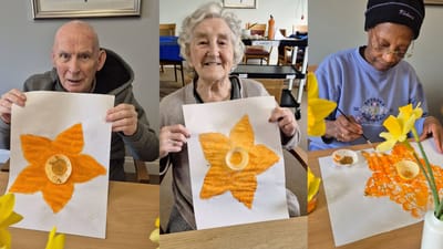 Residents painting flowers during an activity session
