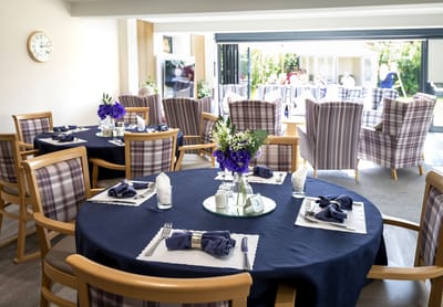 Dining room setup with tables and flowers