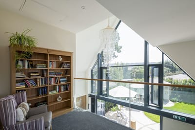Well-lit common area overlooking outdoor patio and garden