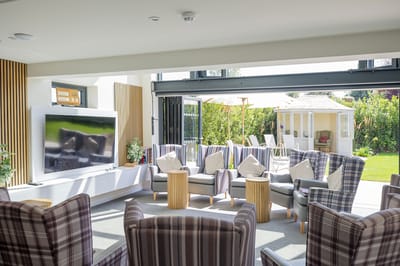 Bright common area with seating and garden view