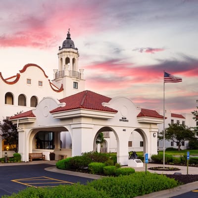 Exterior view of a senior living facility at sunset