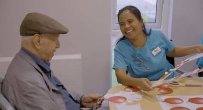 Resident and staff member engaged in an activity