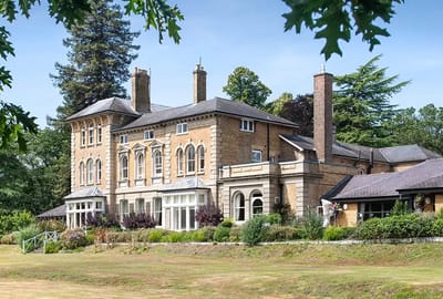 Exterior view of Merlewood Care Home surrounded by greenery