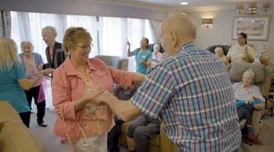 Residents enjoying a dance in a lively common area
