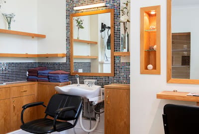 Interior view of a therapy room with a sink and seating
