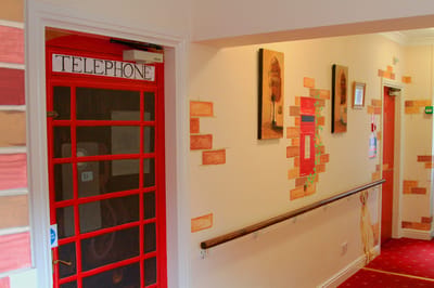 Colorful hallway with telephone booth and art