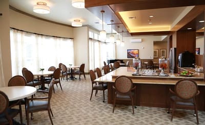 Bright dining area with tables and chairs arranged