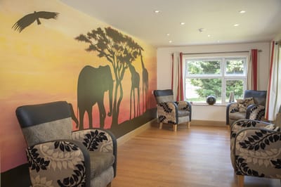 Interior lounge area with scenic mural and seating