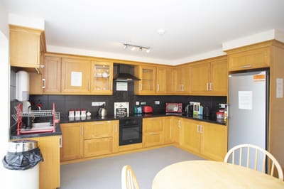 Interior kitchen space with wooden cabinets and appliances